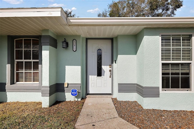 12419 Eryn Ct, Clermont, FL 34711 - view of exterior entry with stucco siding