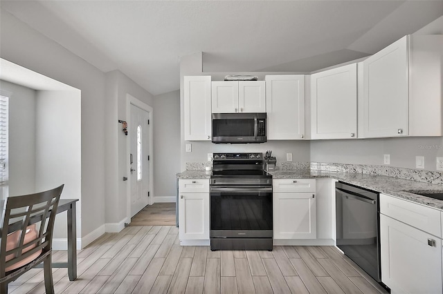12419 Eryn Ct, Clermont, FL 34711 - kitchen with appliances with stainless steel finishes, wood tiled floors, white cabinets, and light stone countertops