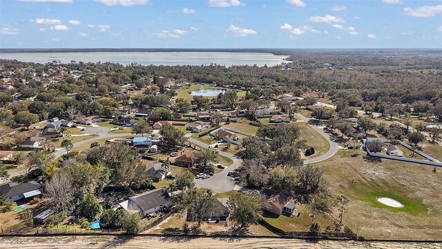 12419 Eryn Ct, Clermont, FL 34711 - aerial overview of property's location with a large body of water and nearby suburban area