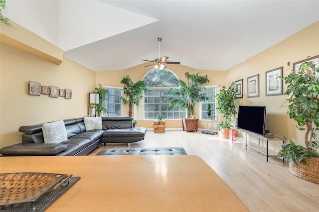 living room with wood finished floors, lofted ceiling, and a ceiling fan