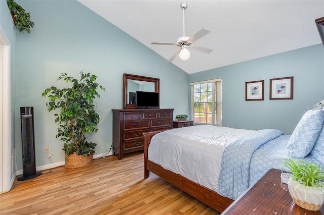 bedroom featuring light wood-style floors, high vaulted ceiling, and a ceiling fan