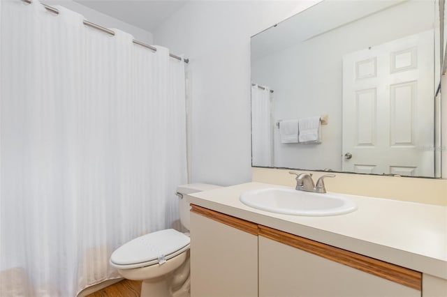 bathroom featuring toilet and vanity
