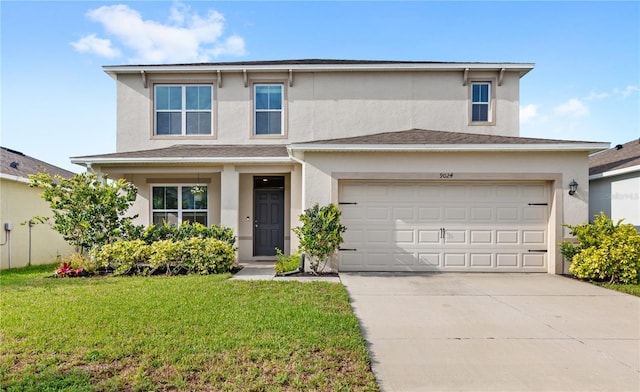 9024 Alba Ln, Kissimmee, FL 34747 - view of front of house with stucco siding, driveway, and a front lawn