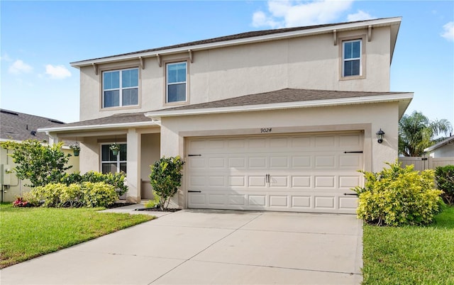 9024 Alba Ln, Kissimmee, FL 34747 - traditional home with stucco siding, a front lawn, driveway, and a garage