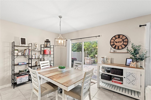 9024 Alba Ln, Kissimmee, FL 34747 - dining area with light tile patterned floors and a chandelier