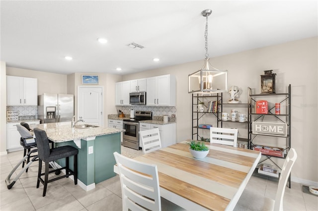 9024 Alba Ln, Kissimmee, FL 34747 - dining area with light tile patterned floors and recessed lighting