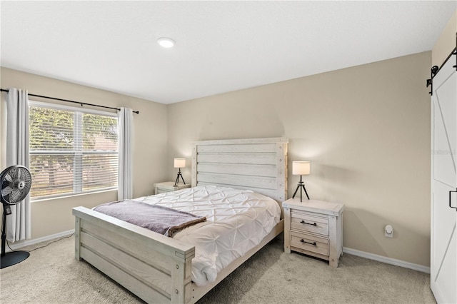 9024 Alba Ln, Kissimmee, FL 34747 - bedroom featuring a barn door and light carpet