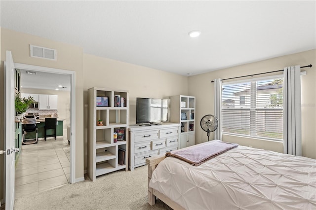 9024 Alba Ln, Kissimmee, FL 34747 - bedroom with light carpet and light tile patterned flooring