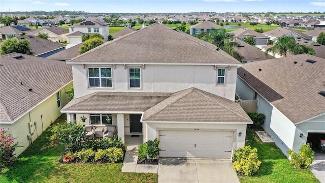9024 Alba Ln, Kissimmee, FL 34747 - view of front of house featuring stucco siding, a shingled roof, driveway, and a residential view