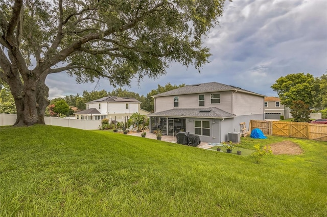 2032 Wavyleaf Ct, Apopka, FL 32712 - rear view of property featuring a sunroom, a fenced backyard, a gate, and a shingled roof