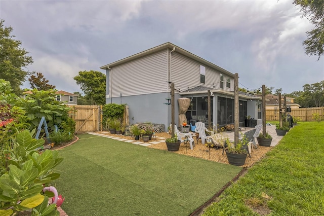 2032 Wavyleaf Ct, Apopka, FL 32712 - back of property featuring a sunroom, a fenced backyard, a patio area, and a gate