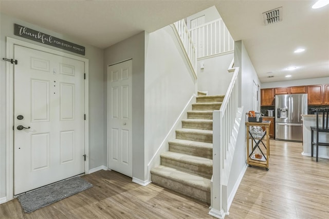 2032 Wavyleaf Ct, Apopka, FL 32712 - foyer entrance featuring light wood-type flooring, stairs, and recessed lighting