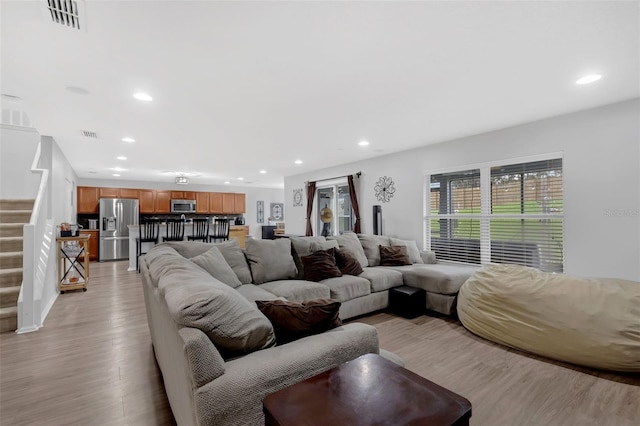 2032 Wavyleaf Ct, Apopka, FL 32712 - living room featuring stairs, light wood-style flooring, and recessed lighting