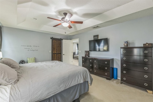 2032 Wavyleaf Ct, Apopka, FL 32712 - carpeted bedroom featuring a raised ceiling, a barn door, and a ceiling fan
