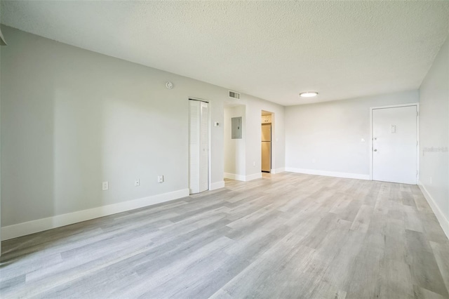 936 Lake Destiny Rd Unit G, Altamonte Springs, FL 32714 - spare room featuring a textured ceiling, light wood-style floors, and electric panel