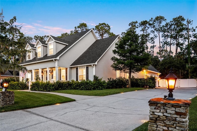 1443 Stone Trl, Enterprise, FL 32725 - cape cod home featuring a yard, a shingled roof, and concrete driveway