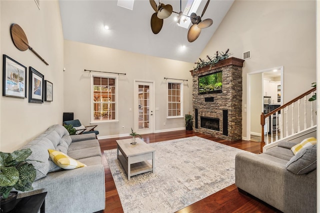 1443 Stone Trl, Enterprise, FL 32725 - living room with a ceiling fan, high vaulted ceiling, a fireplace, stairway, and dark wood-style floors