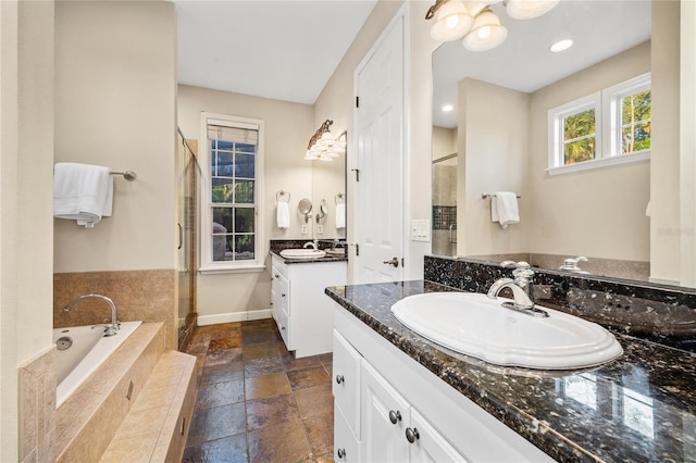 1443 Stone Trl, Enterprise, FL 32725 - full bath featuring stone tile floors, a shower stall, two vanities, and a bath
