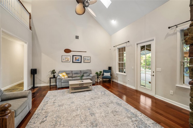 1443 Stone Trl, Enterprise, FL 32725 - living area with high vaulted ceiling, a skylight, dark wood-style floors, and a ceiling fan