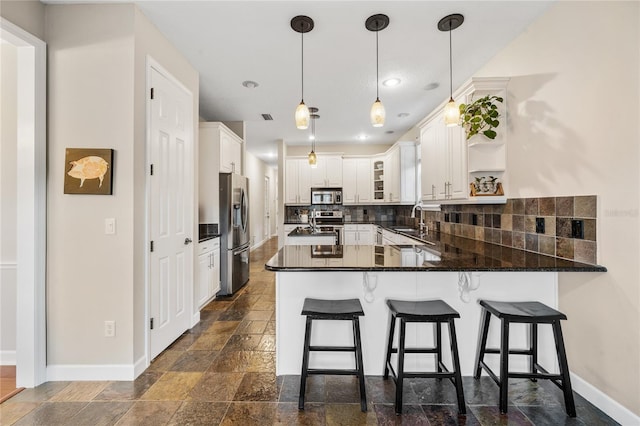 1443 Stone Trl, Enterprise, FL 32725 - kitchen featuring stainless steel appliances, a peninsula, stone tile flooring, decorative backsplash, and open shelves