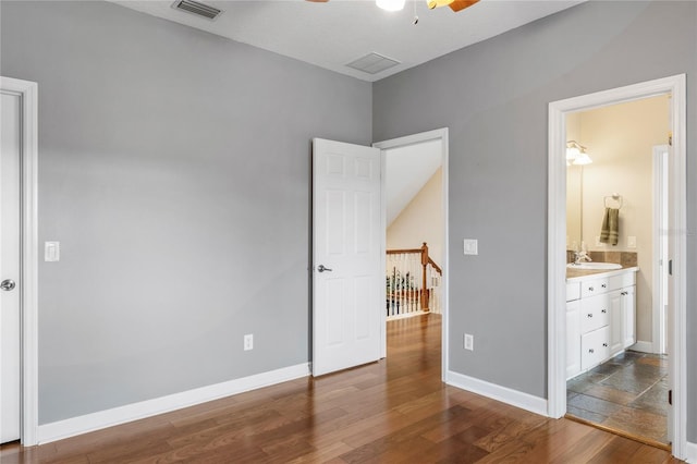 1443 Stone Trl, Enterprise, FL 32725 - unfurnished bedroom featuring dark wood-style flooring and ensuite bathroom