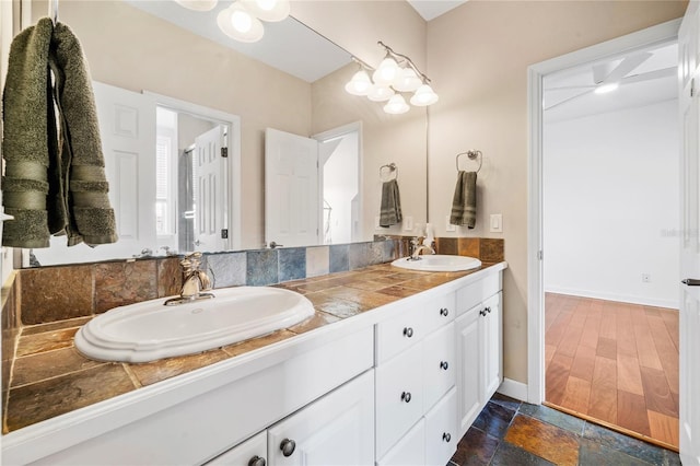 1443 Stone Trl, Enterprise, FL 32725 - full bathroom with double vanity and baseboards