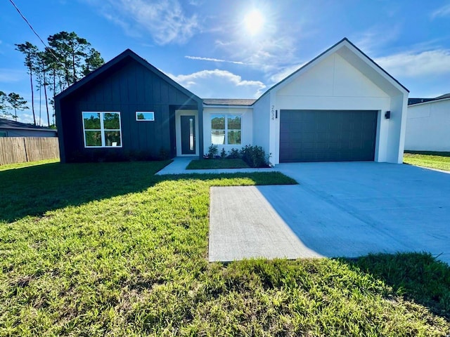 2634 De Groodt Rd SW, Palm Bay, FL 32908 - view of front of property with board and batten siding, driveway, and a garage