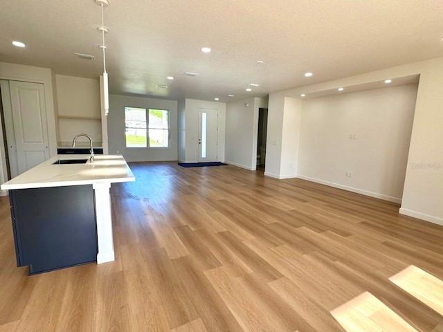 2634 De Groodt Rd SW, Palm Bay, FL 32908 - unfurnished living room featuring recessed lighting, light wood-style flooring, and a textured ceiling