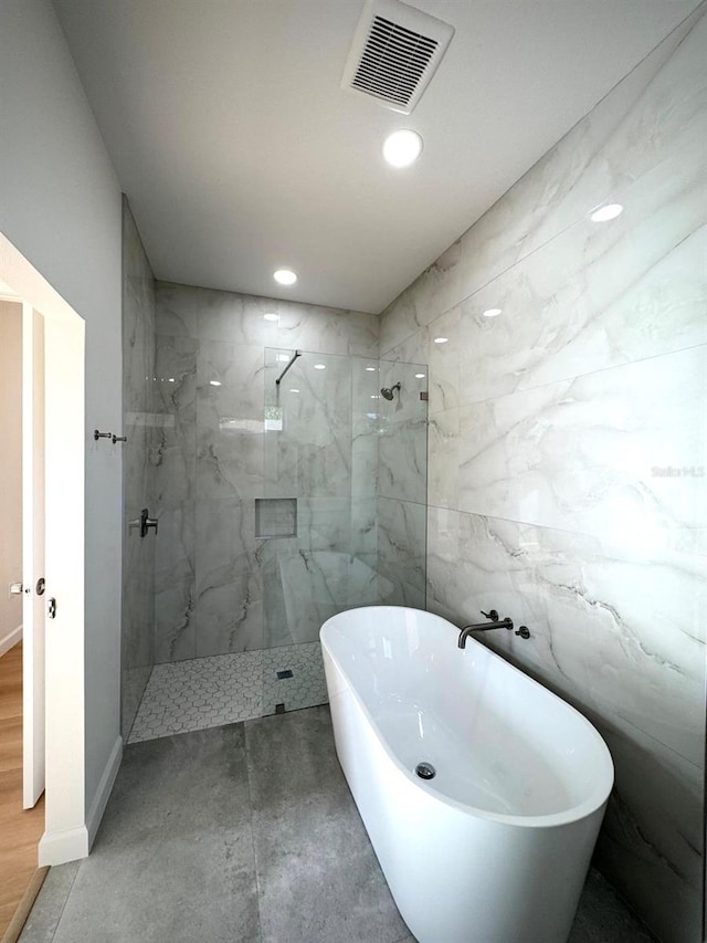 2634 De Groodt Rd SW, Palm Bay, FL 32908 - bathroom featuring a soaking tub, a marble finish shower, and recessed lighting