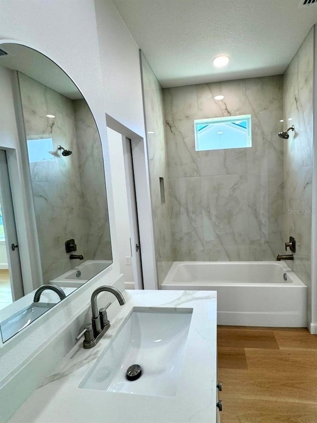 2634 De Groodt Rd SW, Palm Bay, FL 32908 - bathroom featuring bathtub / shower combination, wood finished floors, vanity, and a textured ceiling
