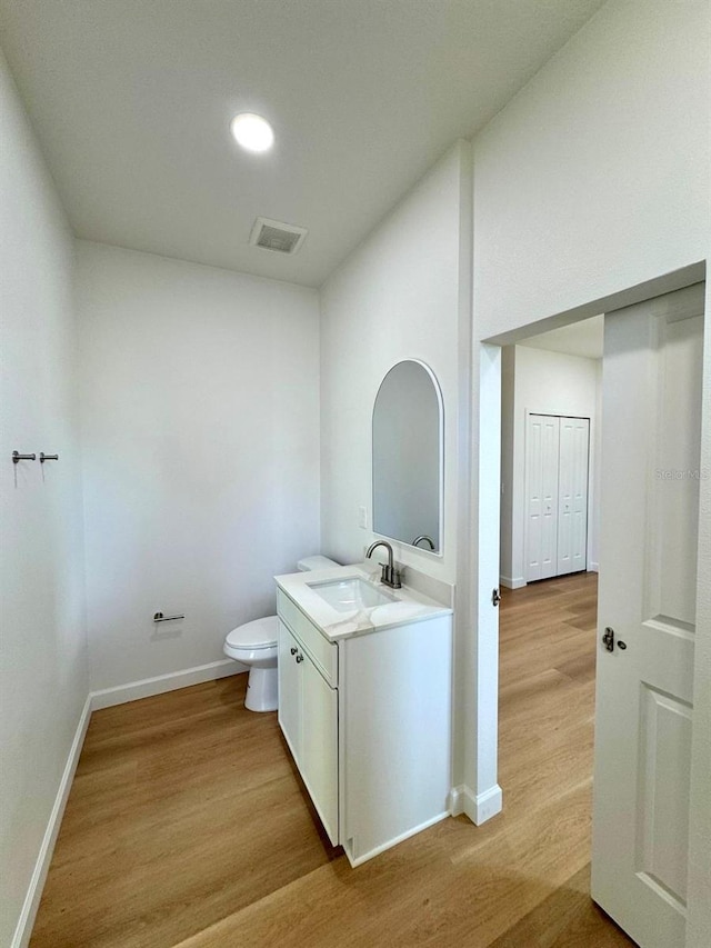 2634 De Groodt Rd SW, Palm Bay, FL 32908 - half bathroom featuring vanity, wood finished floors, and recessed lighting