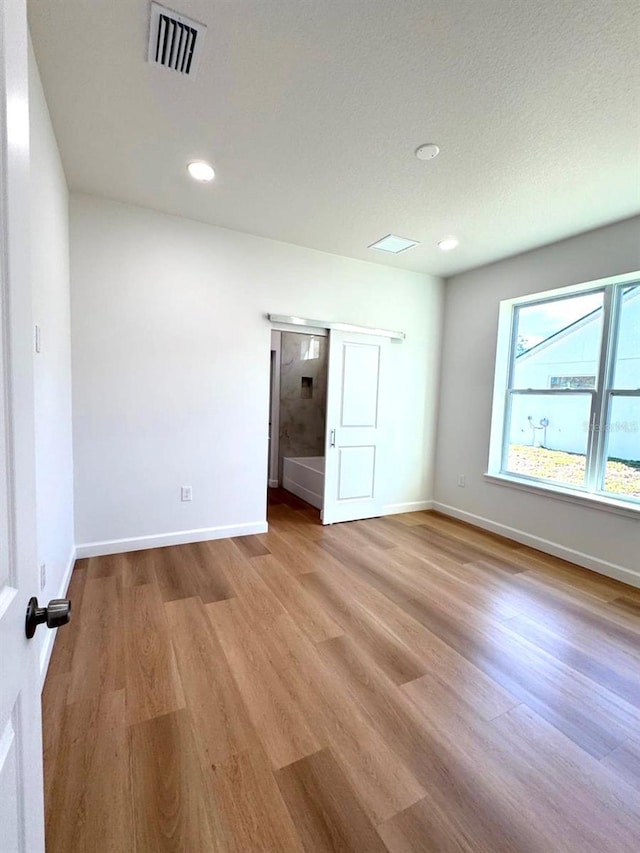 2634 De Groodt Rd SW, Palm Bay, FL 32908 - empty room with wood finished floors and recessed lighting