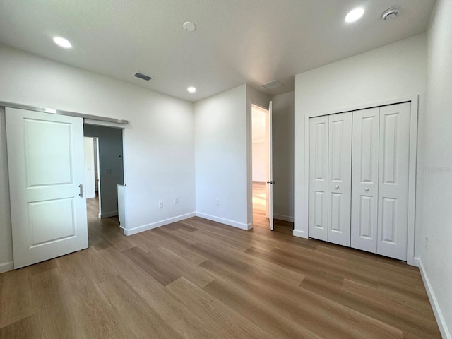 2634 De Groodt Rd SW, Palm Bay, FL 32908 - unfurnished bedroom with light wood-style floors, recessed lighting, and a closet