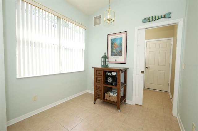 2362 Prairie Dunes, Clermont, FL 34711 - hallway with light tile patterned floors and a chandelier
