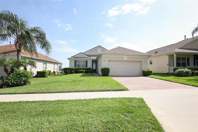 2362 Prairie Dunes, Clermont, FL 34711 - ranch-style house featuring decorative driveway, a garage, a front yard, and stucco siding