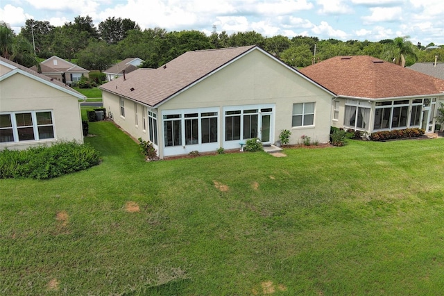 2362 Prairie Dunes, Clermont, FL 34711 - back of property featuring a sunroom, roof with shingles, a yard, and stucco siding