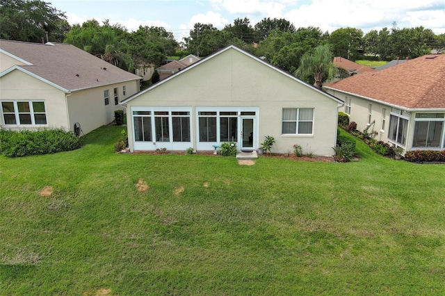 2362 Prairie Dunes, Clermont, FL 34711 - back of property featuring a yard, a sunroom, and stucco siding