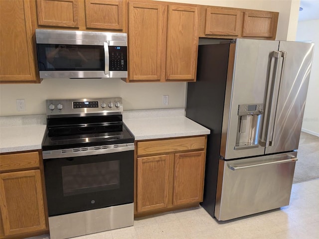 1027 Sheeler Hills Dr, Apopka, FL 32703 - kitchen with appliances with stainless steel finishes, light countertops, light flooring, and brown cabinets