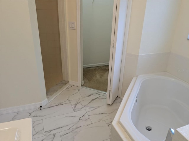 1027 Sheeler Hills Dr, Apopka, FL 32703 - full bath with a garden tub, marble finish flooring, and a tile shower