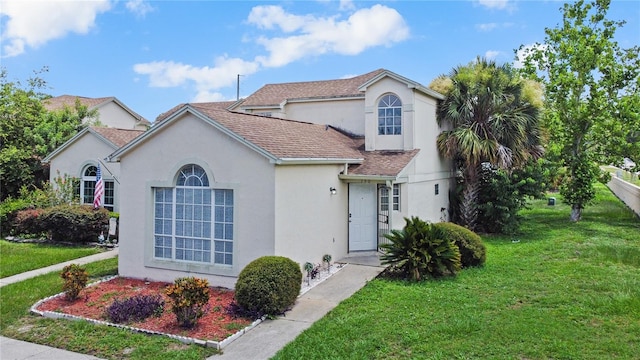 750 Olympic Cir Unit D1, Ocoee, FL 34761 - view of front of house with stucco siding, a front yard, and a shingled roof