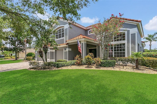 2388 Baronsmede Ct, Winter Garden, FL 34787 - mediterranean / spanish-style home featuring stucco siding, a tile roof, a front yard, driveway, and a garage