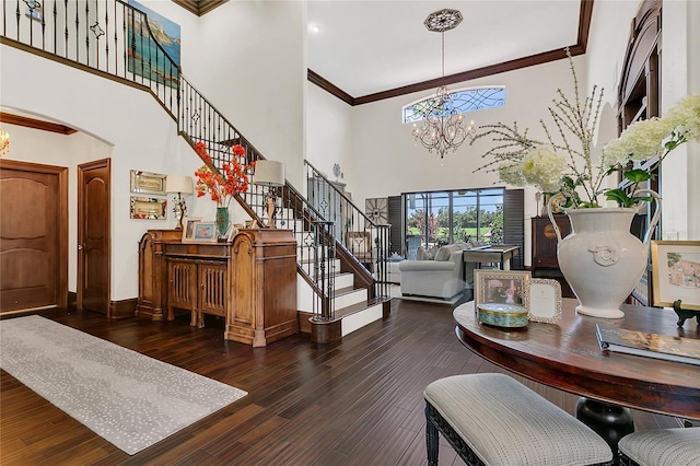 2388 Baronsmede Ct, Winter Garden, FL 34787 - foyer with a towering ceiling, a chandelier, stairs, crown molding, and hardwood / wood-style floors
