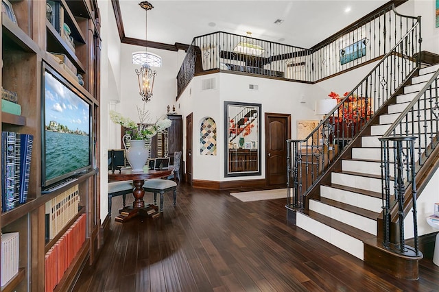 2388 Baronsmede Ct, Winter Garden, FL 34787 - foyer featuring a chandelier, a towering ceiling, stairway, wood finished floors, and crown molding