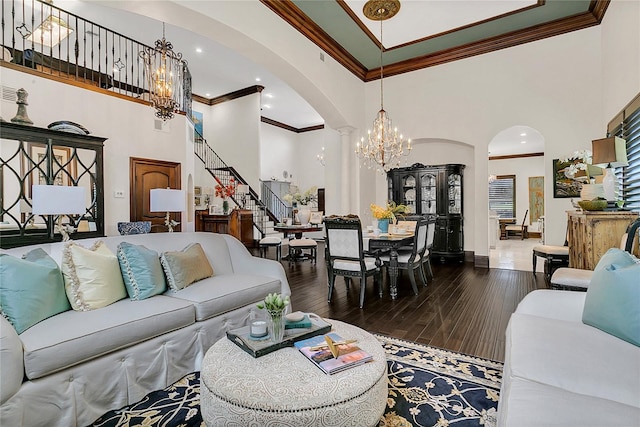 2388 Baronsmede Ct, Winter Garden, FL 34787 - living area featuring arched walkways, a chandelier, a high ceiling, ornamental molding, and hardwood / wood-style floors