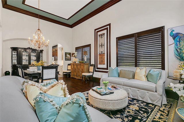 2388 Baronsmede Ct, Winter Garden, FL 34787 - living room featuring ornamental molding, a chandelier, arched walkways, and wood finished floors