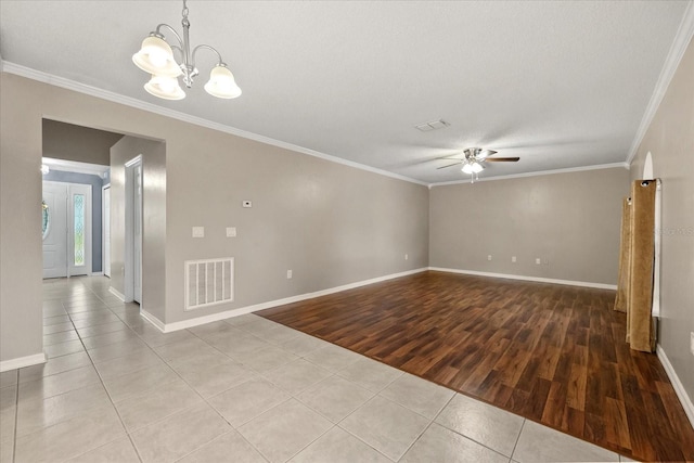 2725 White Magnolia Loop, Clermont, FL 34711 - unfurnished room with tile patterned flooring, crown molding, ceiling fan, and a chandelier