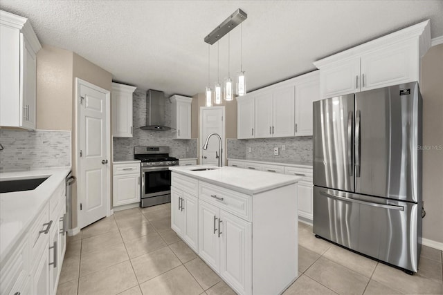 2725 White Magnolia Loop, Clermont, FL 34711 - kitchen featuring appliances with stainless steel finishes, wall chimney range hood, an island with sink, light countertops, and decorative backsplash
