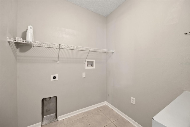 2725 White Magnolia Loop, Clermont, FL 34711 - laundry area with hookup for a washing machine, electric dryer hookup, and light tile patterned floors