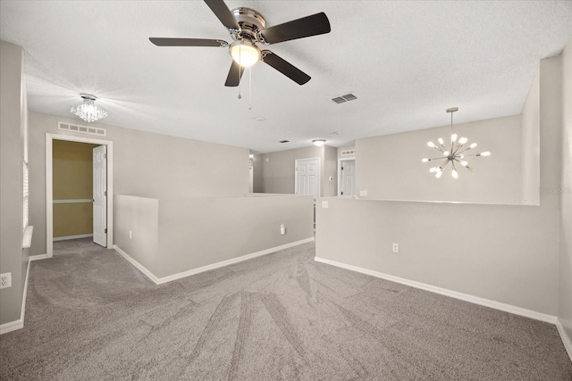 2725 White Magnolia Loop, Clermont, FL 34711 - carpeted spare room featuring a chandelier, a ceiling fan, and a textured ceiling