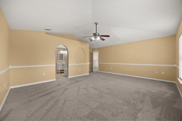 2725 White Magnolia Loop, Clermont, FL 34711 - unfurnished room with ceiling fan, vaulted ceiling, carpet flooring, and arched walkways